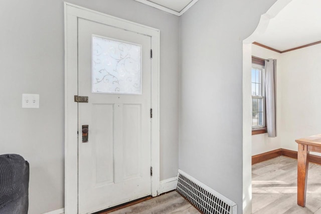 entryway featuring crown molding, wood finished floors, baseboards, and visible vents