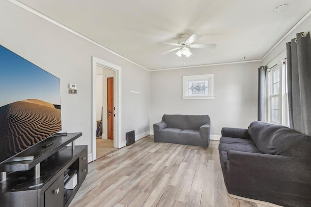 living room with light wood-style flooring, baseboards, a ceiling fan, and ornamental molding