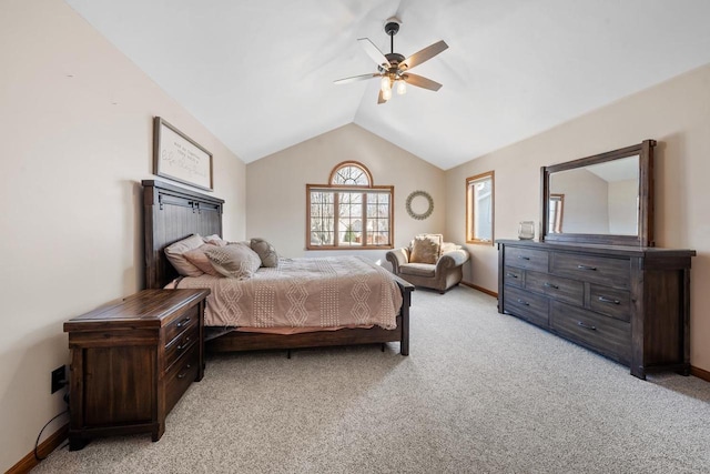 bedroom with light carpet, ceiling fan, baseboards, and vaulted ceiling