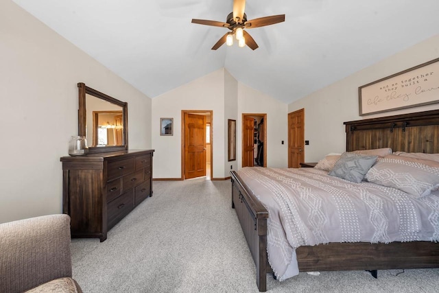 bedroom featuring baseboards, lofted ceiling, ceiling fan, a spacious closet, and light colored carpet