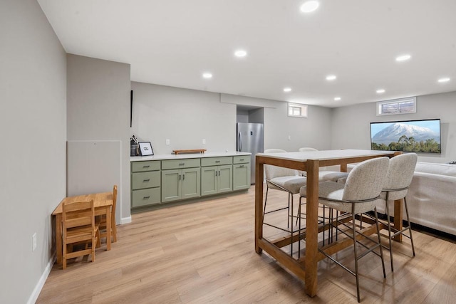 dining room featuring recessed lighting, baseboards, and light wood-style floors