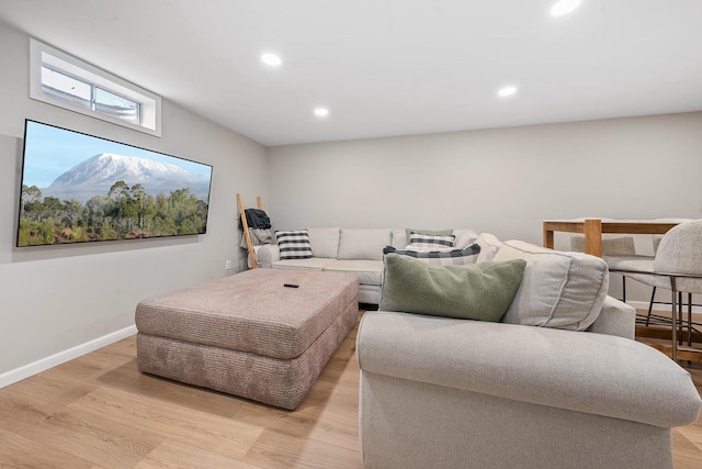 living room with recessed lighting, baseboards, and light wood finished floors