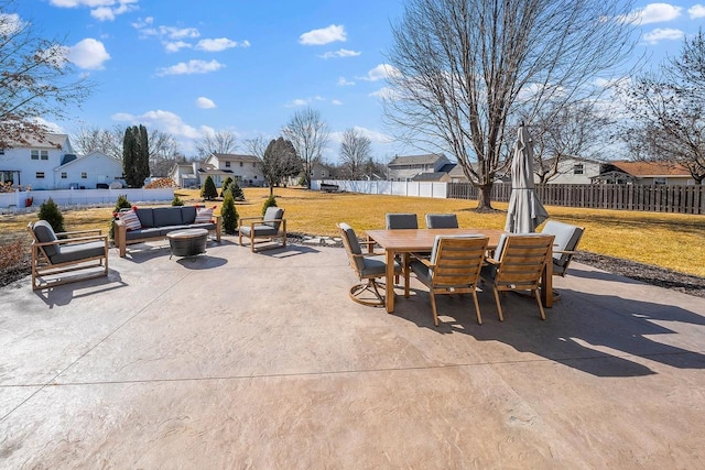 view of patio / terrace with an outdoor living space with a fire pit, outdoor dining area, a fenced backyard, and a residential view