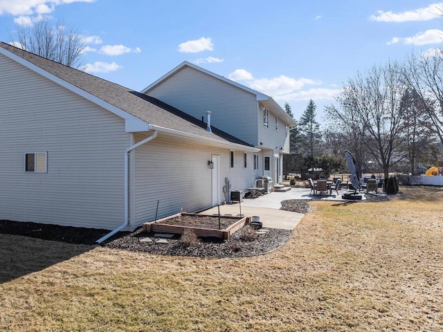 rear view of property with a patio and a lawn