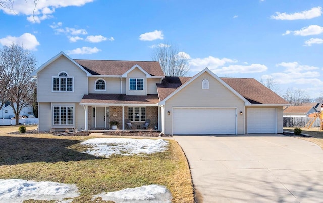 traditional-style home with a front yard, fence, driveway, a porch, and an attached garage