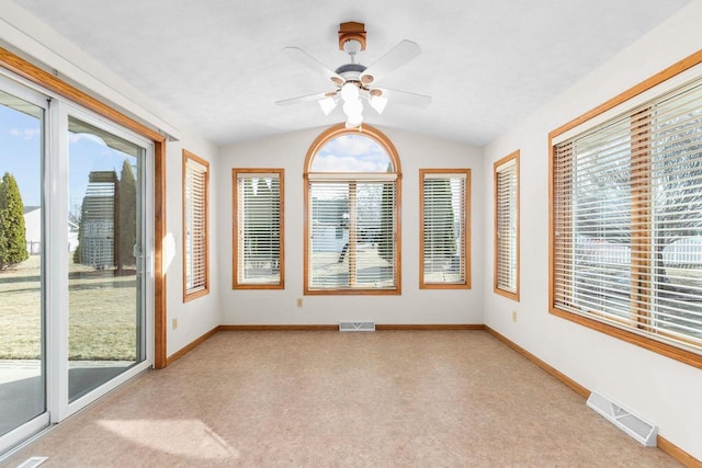 unfurnished sunroom with visible vents, ceiling fan, and vaulted ceiling