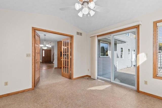 empty room featuring visible vents, lofted ceiling, baseboards, and ceiling fan with notable chandelier