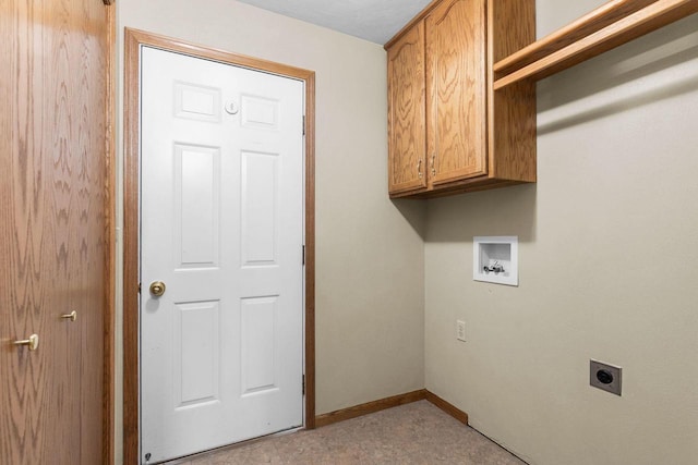 clothes washing area featuring cabinet space, electric dryer hookup, baseboards, and washer hookup