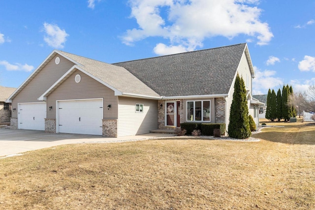 view of front of house with a garage, a front yard, brick siding, and driveway