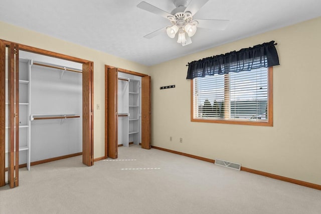 unfurnished bedroom featuring visible vents, carpet floors, baseboards, and ceiling fan