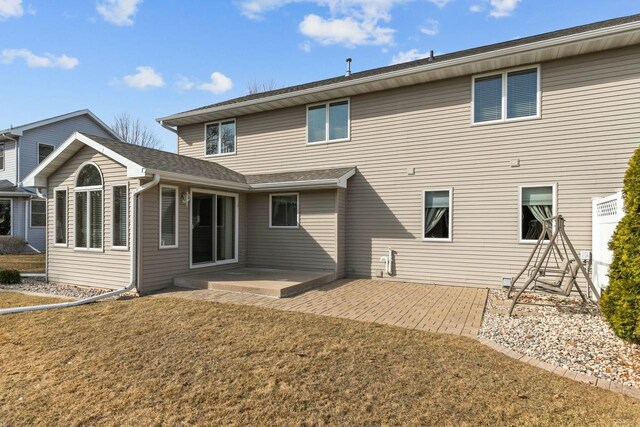 rear view of property with a patio area and a lawn