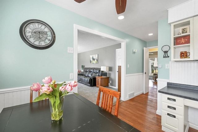 dining room with wood finished floors, a wainscoted wall, a ceiling fan, visible vents, and recessed lighting