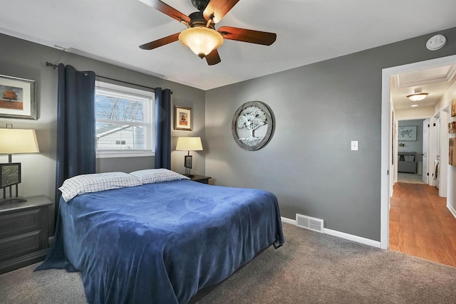 bedroom featuring a ceiling fan, carpet flooring, baseboards, and visible vents