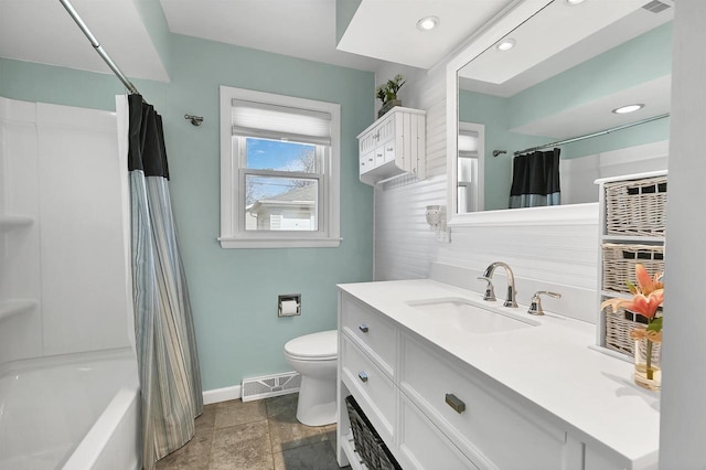 bathroom featuring visible vents, baseboards, toilet, shower / tub combo, and vanity