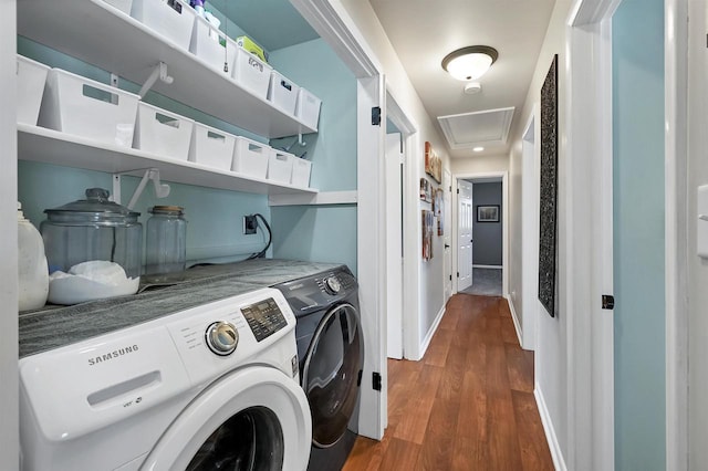 laundry area featuring baseboards, separate washer and dryer, attic access, and wood finished floors