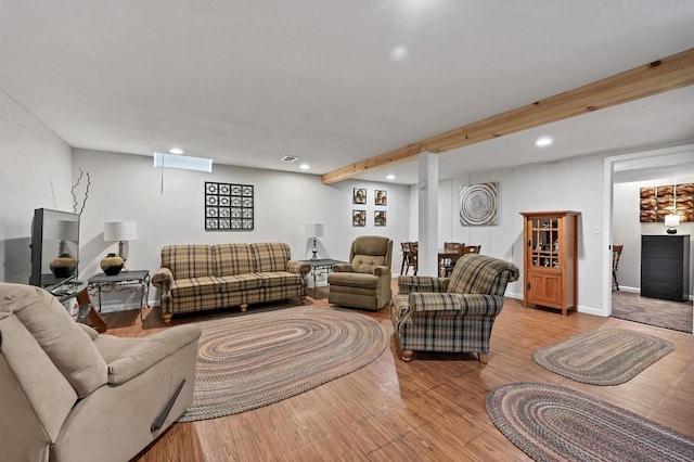 living area with beamed ceiling, recessed lighting, and wood finished floors