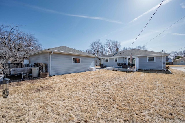 back of house featuring a wooden deck