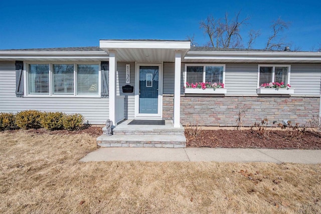 doorway to property featuring stone siding