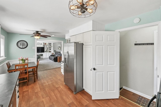 kitchen featuring white cabinetry, open floor plan, light wood-style floors, and stainless steel refrigerator with ice dispenser