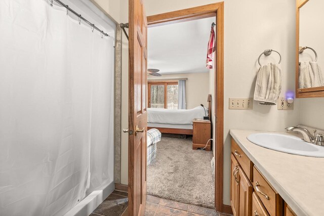 ensuite bathroom featuring curtained shower, vanity, and ensuite bathroom