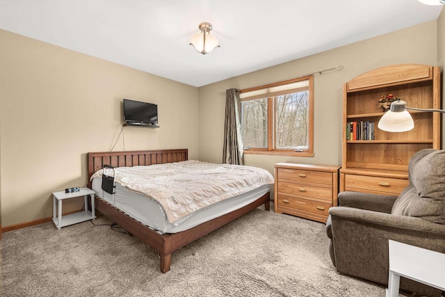 bedroom featuring baseboards and light carpet