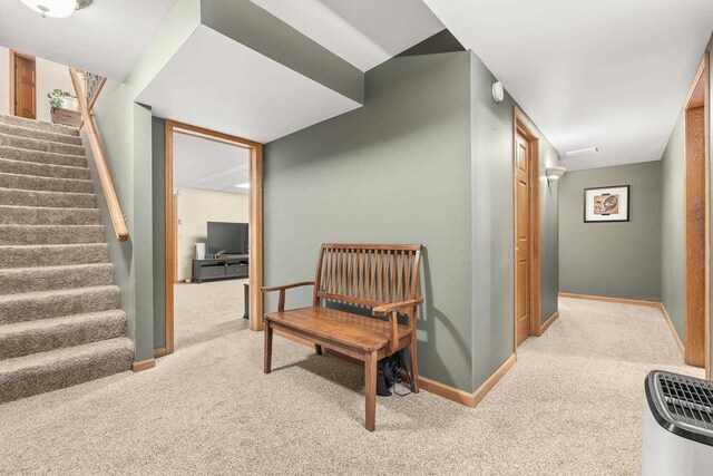 interior space featuring stairs, baseboards, and carpet floors