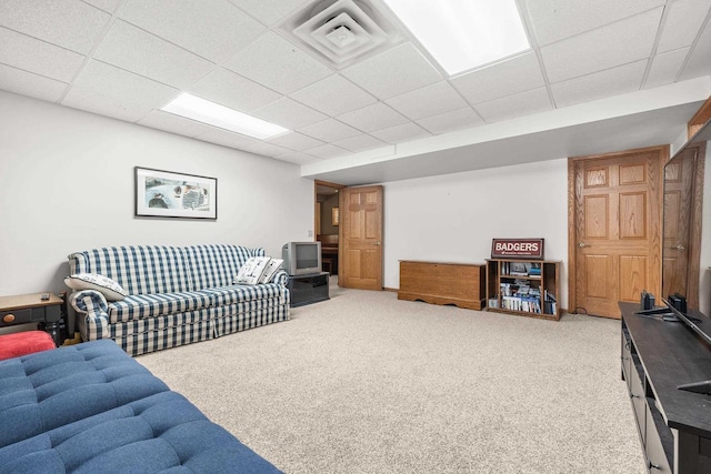 living room featuring carpet flooring, visible vents, and a drop ceiling