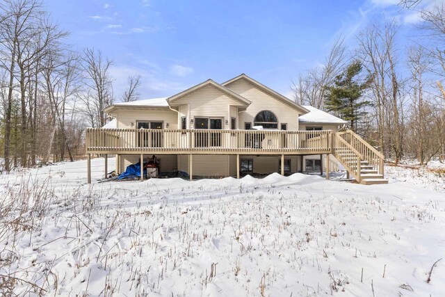 snow covered property featuring a deck