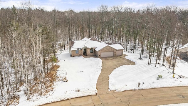 snowy aerial view with a forest view