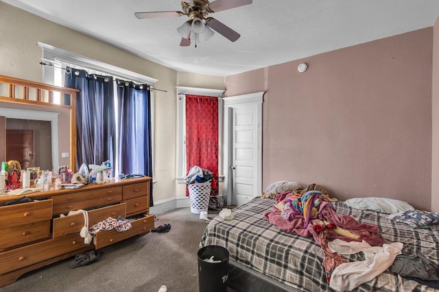 bedroom with baseboards, carpet floors, and a ceiling fan