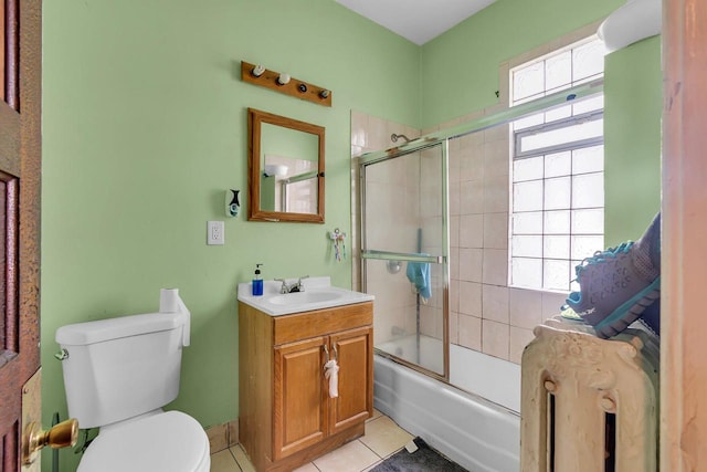 full bathroom featuring enclosed tub / shower combo, toilet, vanity, and tile patterned flooring