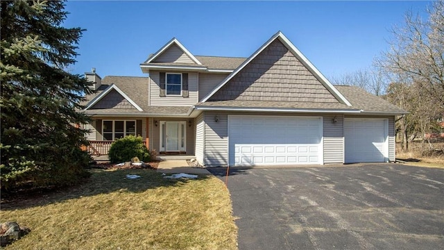 view of front of home featuring a front lawn, a garage, driveway, and a shingled roof