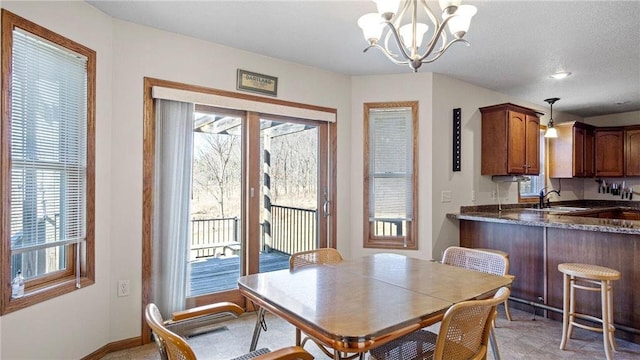 dining space featuring baseboards and a chandelier