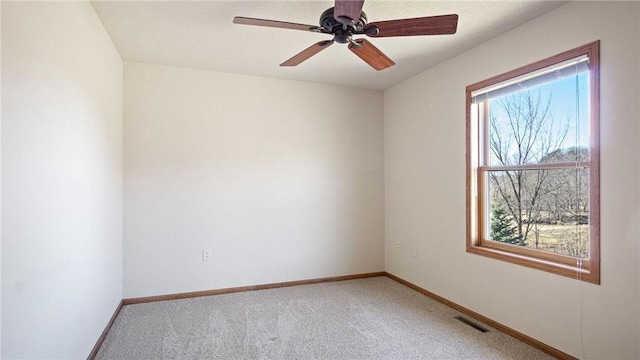 empty room featuring visible vents, baseboards, and light colored carpet