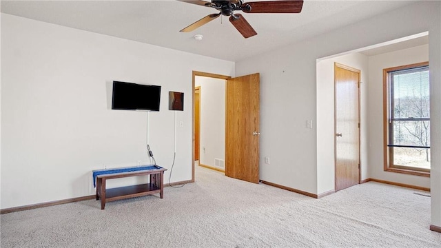 carpeted bedroom featuring visible vents, a ceiling fan, and baseboards