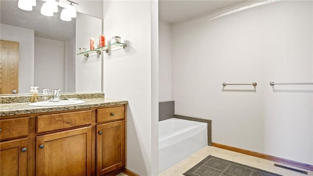 full bath with visible vents, baseboards, a bath, and vanity