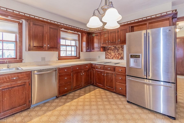 kitchen featuring a sink, light floors, appliances with stainless steel finishes, and light countertops