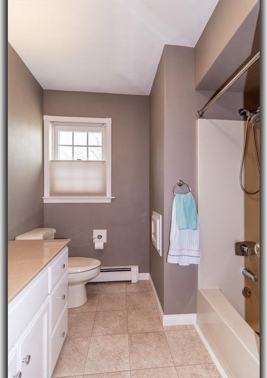 full bathroom with vanity, baseboards, tile patterned flooring, shower / bathing tub combination, and baseboard heating