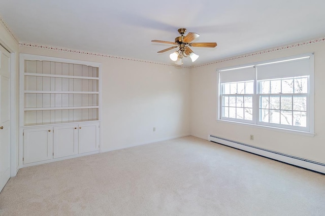 spare room with baseboard heating, light colored carpet, and ceiling fan