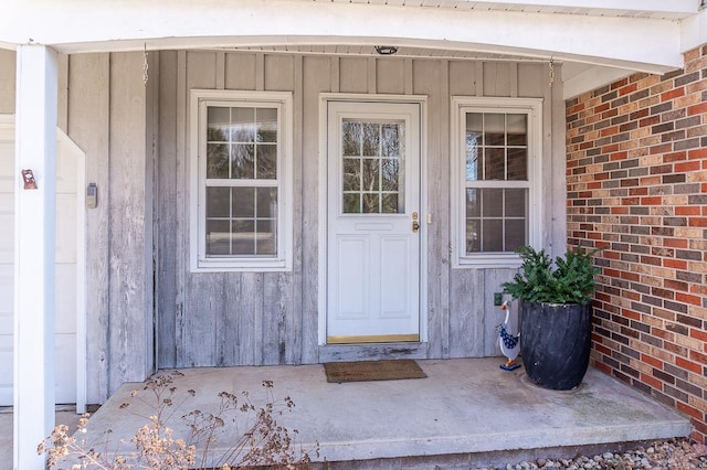 entrance to property featuring brick siding