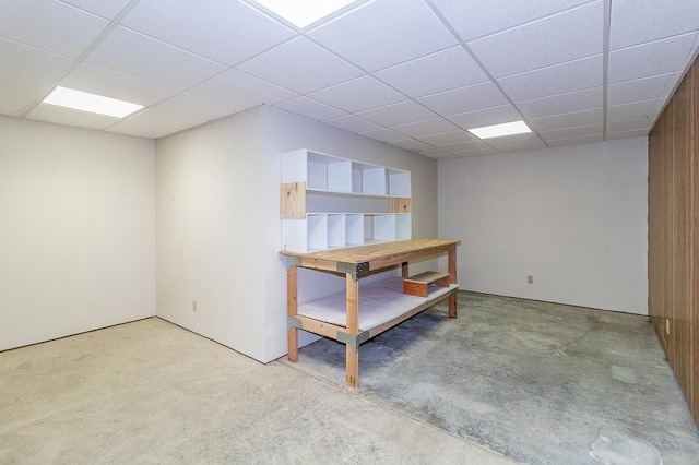 basement with a paneled ceiling