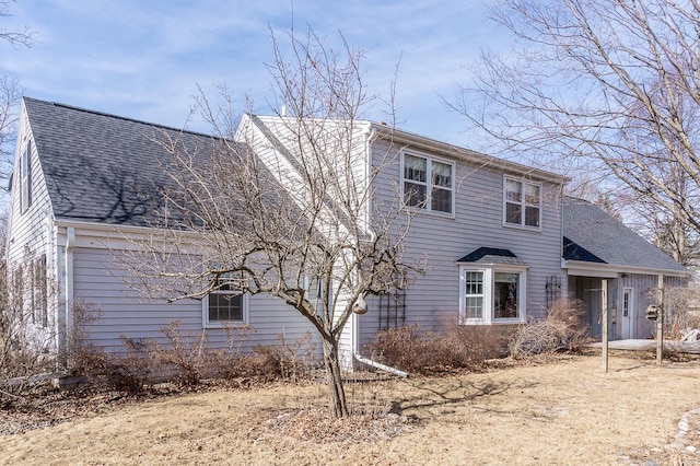 view of front of property featuring roof with shingles