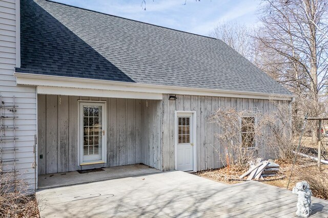 exterior space featuring a deck and roof with shingles