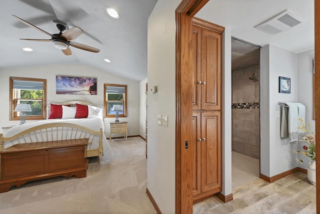 bedroom with vaulted ceiling, light colored carpet, visible vents, and baseboards