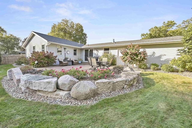 back of property featuring a patio, fence, and a lawn