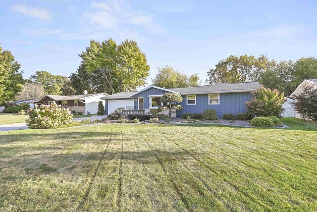 ranch-style home with an attached garage and a front yard