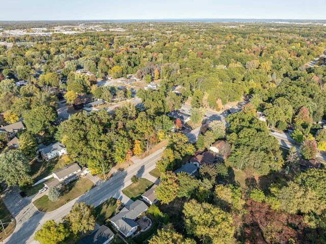 birds eye view of property with a forest view