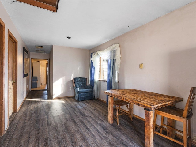 dining area with baseboards and wood finished floors