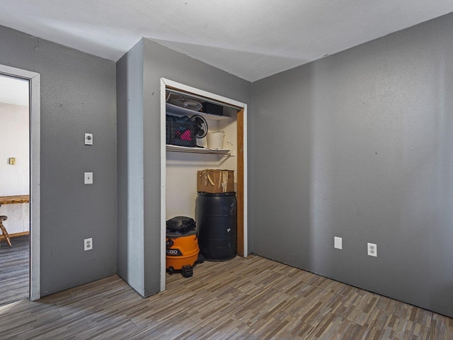 unfurnished bedroom featuring a closet and wood finished floors