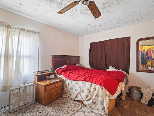 bedroom with a ceiling fan and carpet flooring